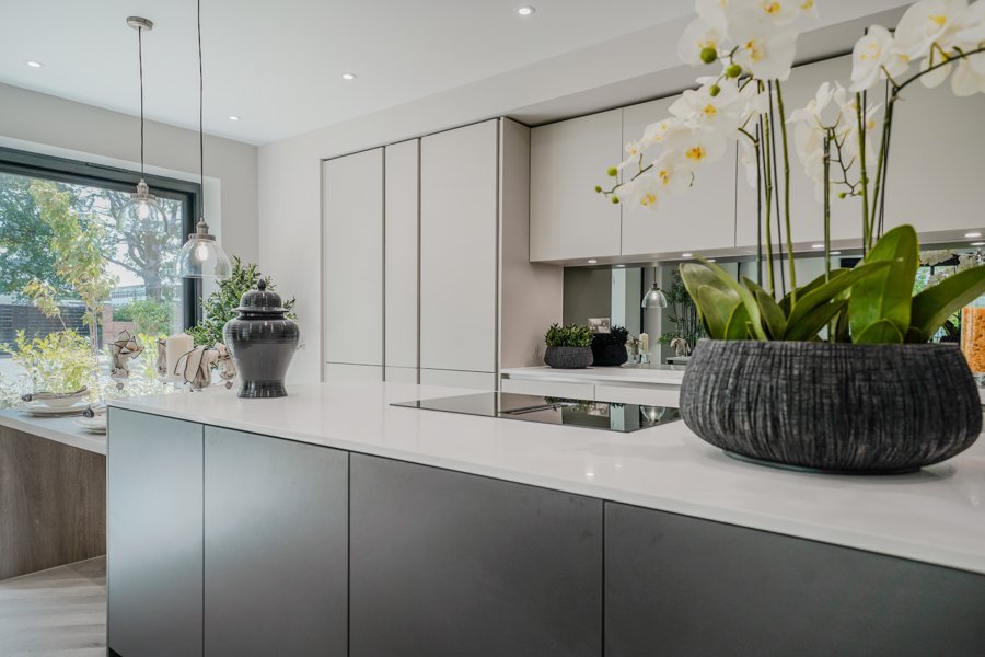 Contemporary kitchen with stone worktops and island